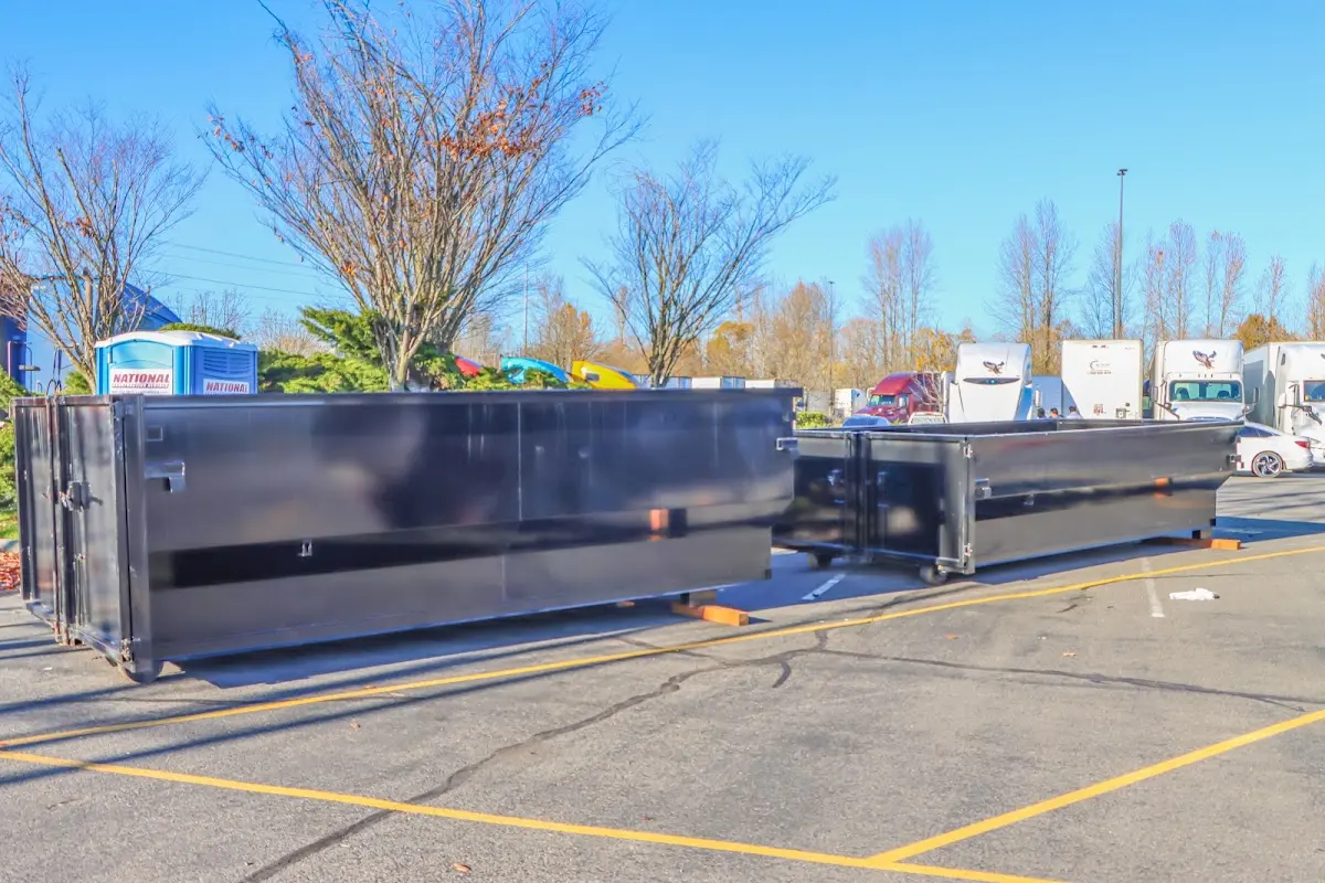 Professional dumpster rental service with roll-off container on residential driveway in Bowie